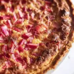 Crustless rhubarb custard pie cooling on table
