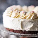 Brownie Ice Cream Cake on a wooden table with layers of ice cream and chocolate shell