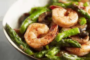 stir-fried shrimp, asparagus, and mushrooms on plate