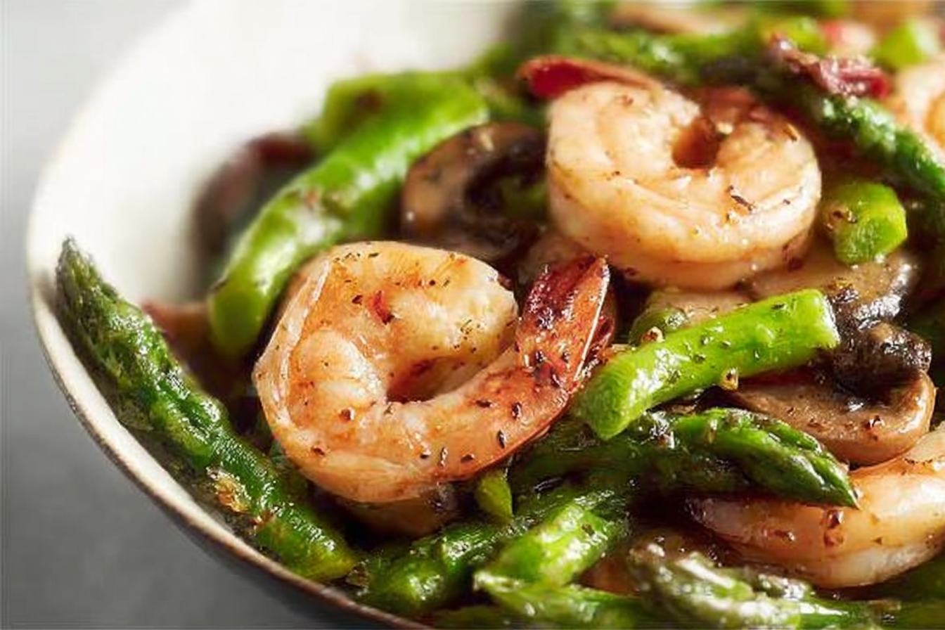 stir-fried shrimp, asparagus, and mushrooms on plate