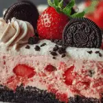 strawberry cake with Oreo crumble and cookies n cream icing on a plate