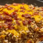 Skillet of bacon cheeseburger rice with cheese and bacon