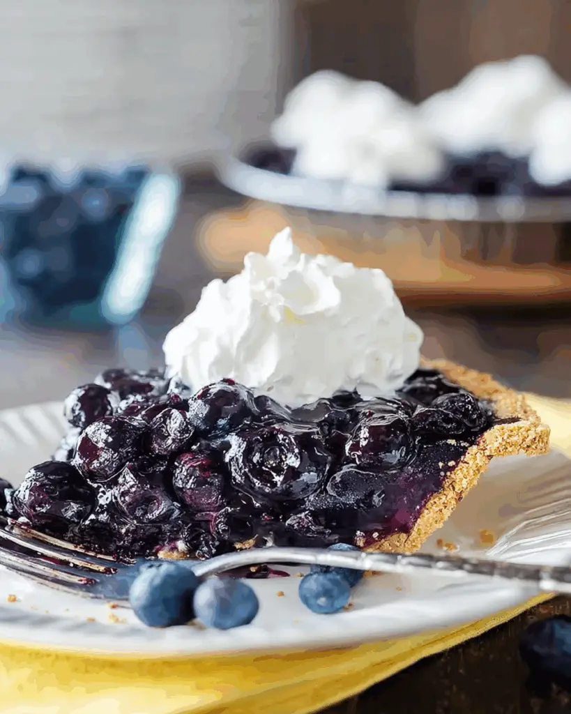 Blueberry filling poured into pie crust
