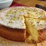 Lemon pistachio ricotta cloud cake topped with pistachios and lemon zest