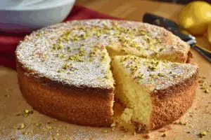 Lemon pistachio ricotta cloud cake topped with pistachios and lemon zest