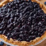 Whole no-bake blueberry pie on a summer kitchen table