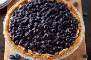 Whole no-bake blueberry pie on a summer kitchen table