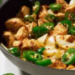 A vibrant bowl of spicy jalapeño chicken stir fry with rice