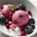 Berries Cottage Cheese Ice Cream in a rustic bowl with fresh berries