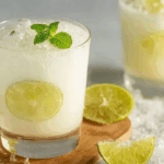 Brazilian Lemonade Recipe frothy glass with lime and mint