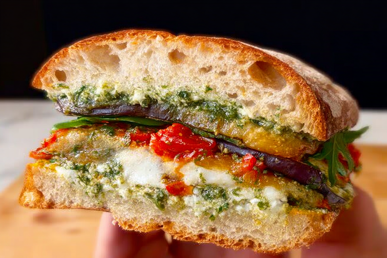 Eggplant pesto sandwich on sourdough with arugula and cherry tomatoes