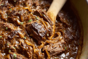 French Onion Pot Roast with caramelized onions and Gruyère cheese in a Dutch oven