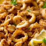 Crispy fried calamari recipe served with lemon wedges