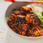 Korean BBQ Chicken sizzling on charcoal grill with smoky glaze