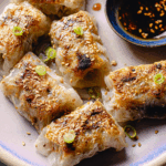 Crispy rice paper dumplings served with scallions and sesame seeds