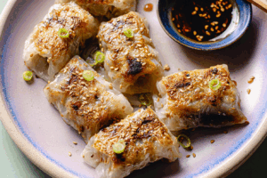Crispy rice paper dumplings served with scallions and sesame seeds