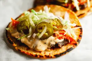 Smash Burger Tacos recipe served fresh with melty cheese, lettuce, and pickles